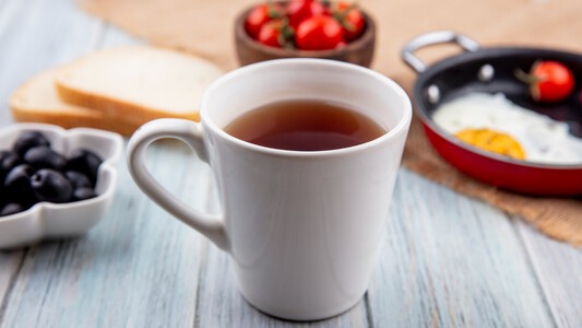 Cup of tea in front of breakfast food