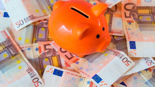 Piggy bank next to euro notes