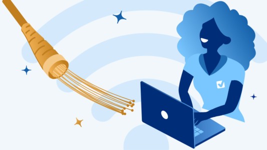 Person on a laptop next to a SIRO broadband cable