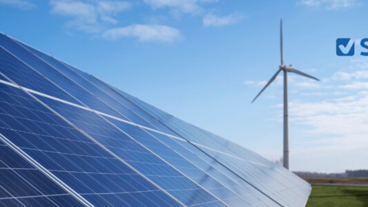 Solar panels next to a wind turbine