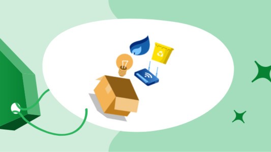 Recycling items inside a cardboard box, wrapped a environmentally friendly green tag