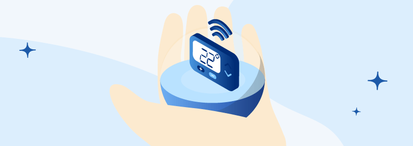 A Netatmo smart thermostat held in a hand