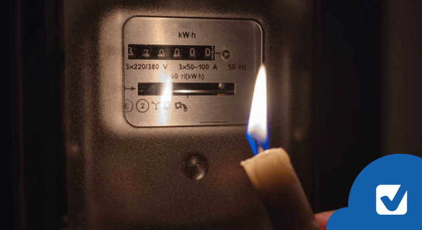 Lit candle in front of electricity meter